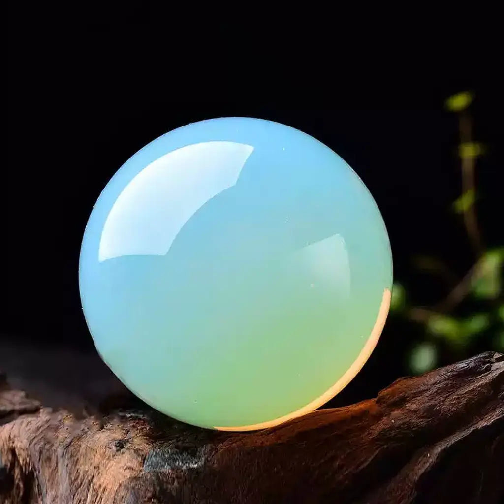 Blue Opal Crystal Sphere on Wood