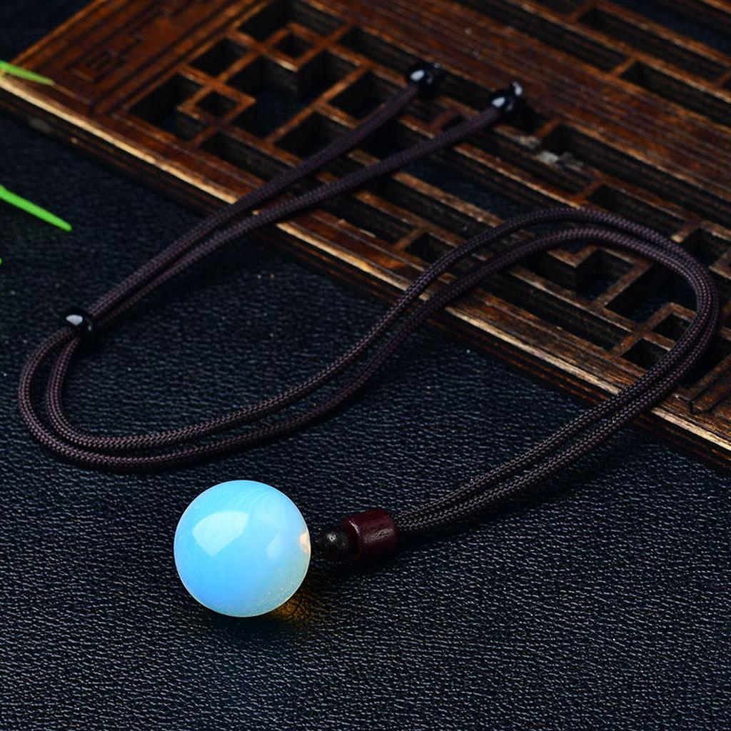 Blue Opalite Sphere Pendant Cord Necklace Wooden Background