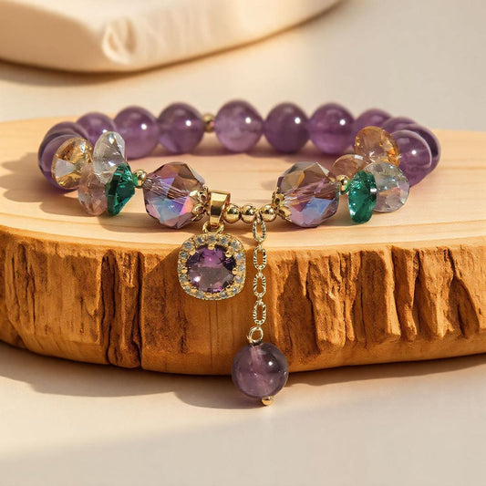 Custom amethyst and crystal bead bracelet displayed on a wooden surface