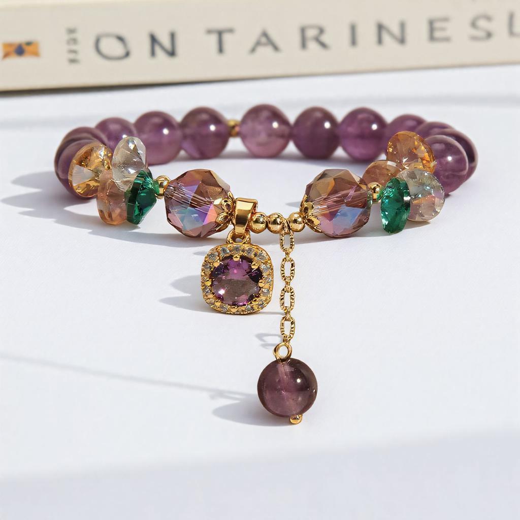 Handmade amethyst beaded bracelet with charm under sunlight