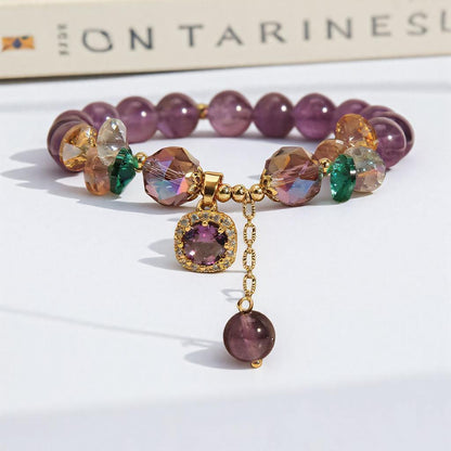 Handmade amethyst beaded bracelet with charm under sunlight