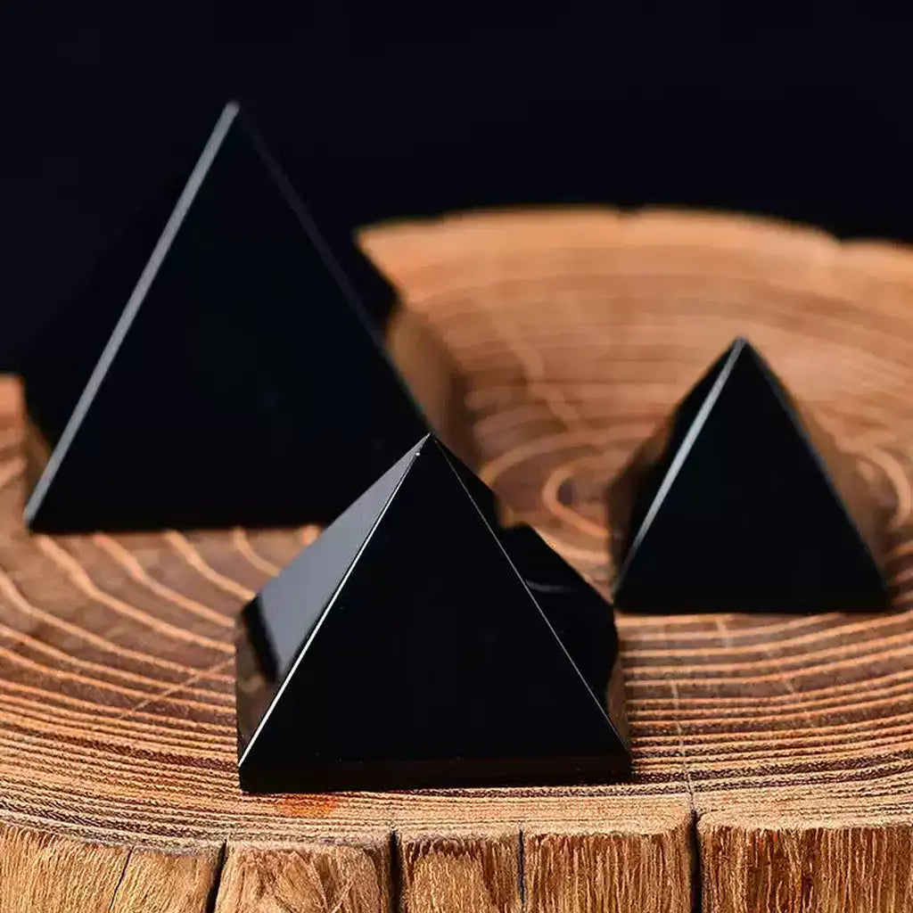 Black Obsidian Pyramid Set Wooden Background