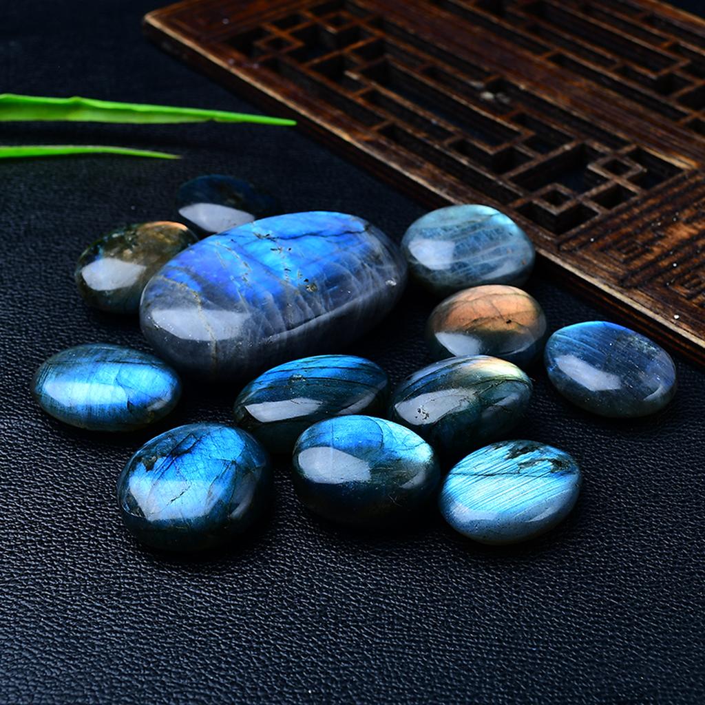Blue Labradorite Palm Stones Black Leather Background