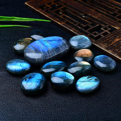 Blue Labradorite Palm Stones Black Leather Background