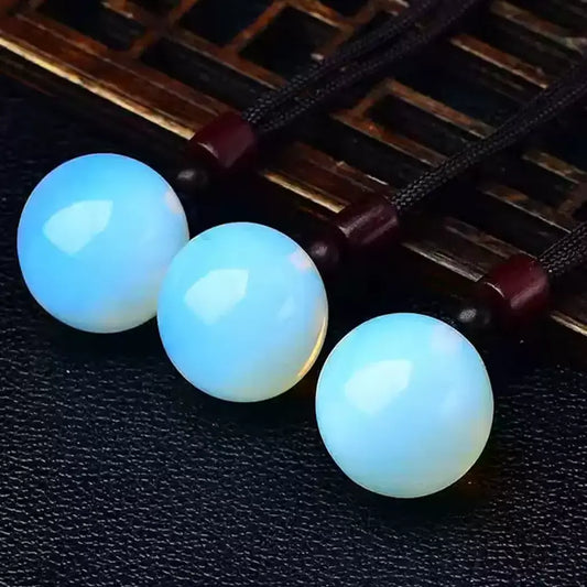 Blue Opalite Crystal Sphere Pendants Wooden Background