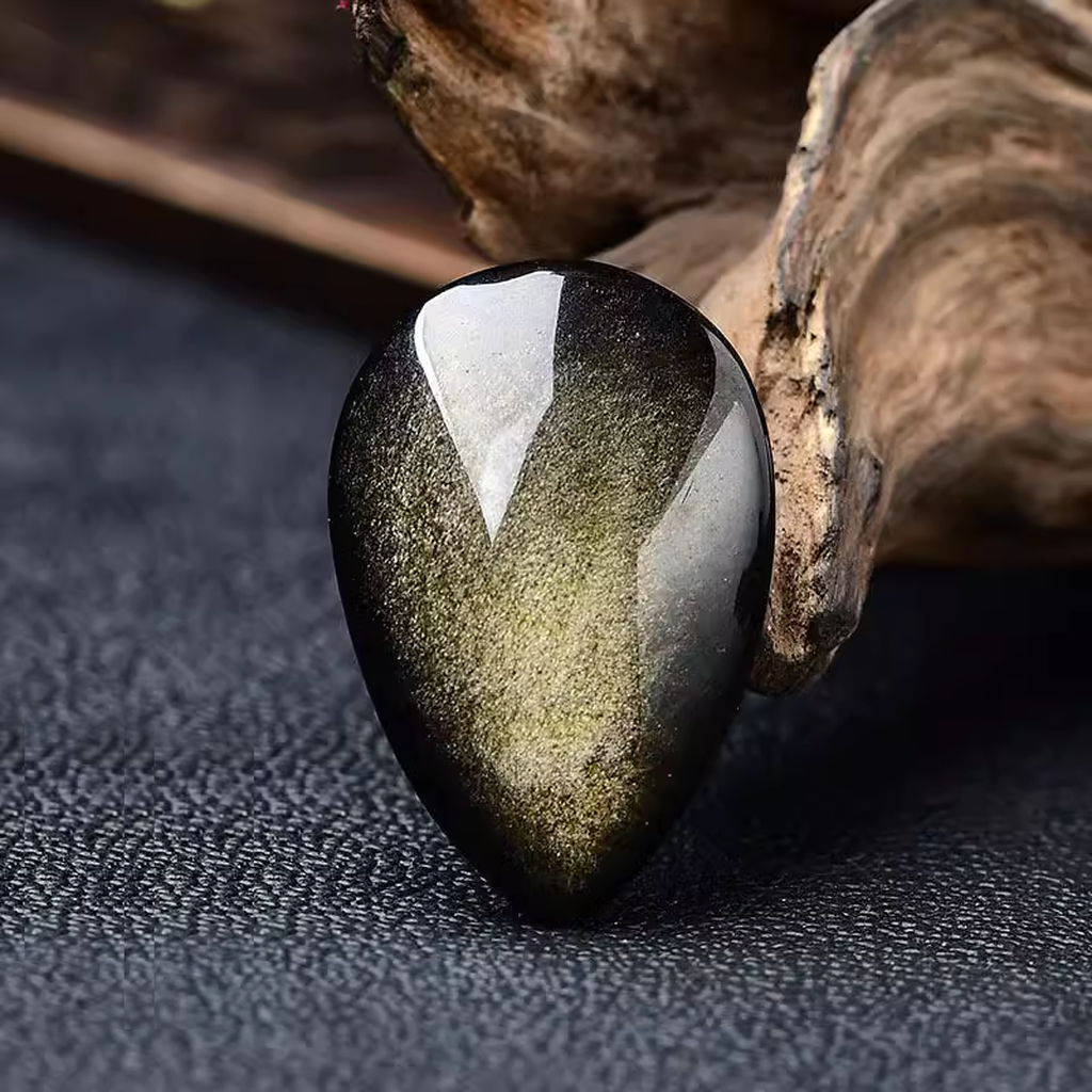Golden Sheen Obsidian Cabochon Wood Background