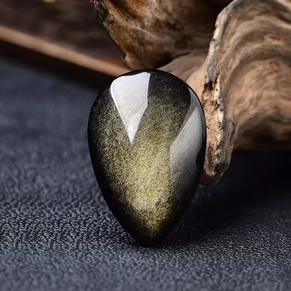 Golden Sheen Obsidian Cabochon Wood Background