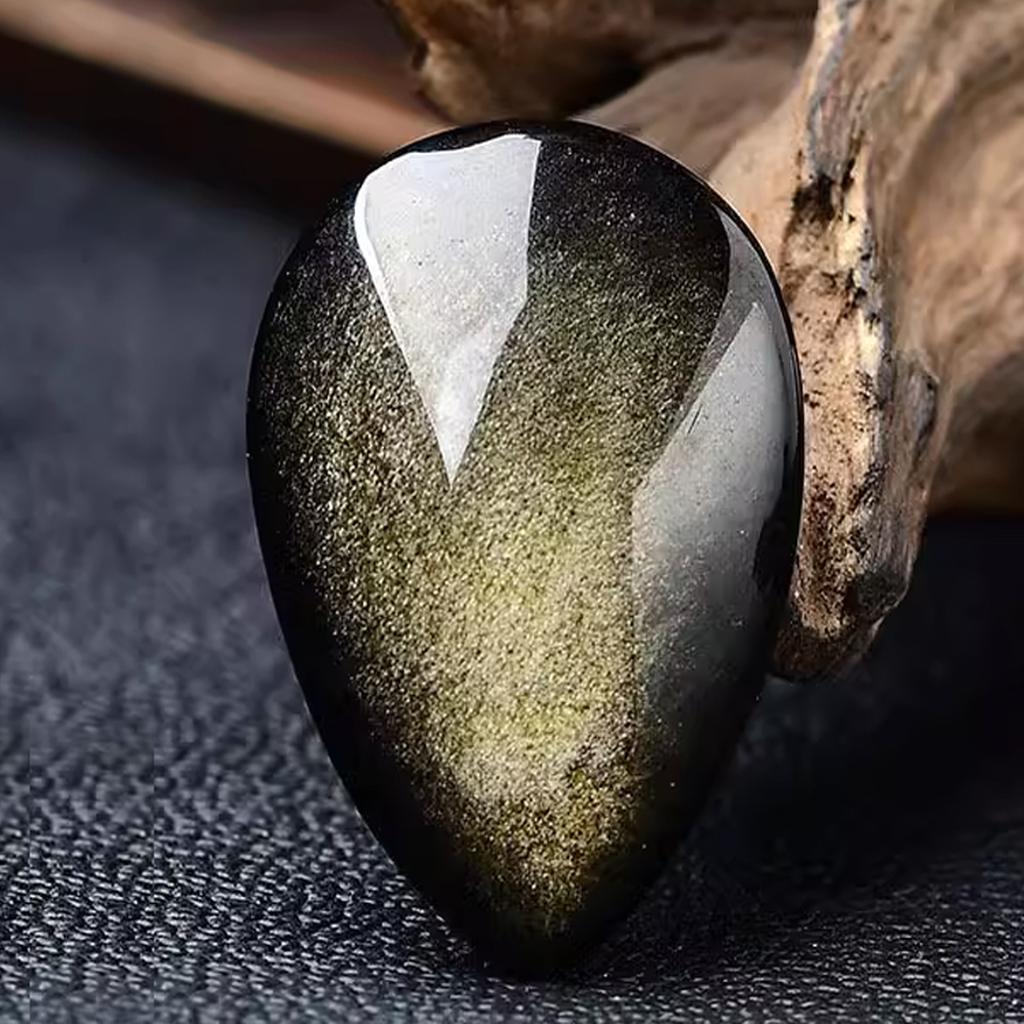 Golden Sheen Obsidian Cabochon Wood Background