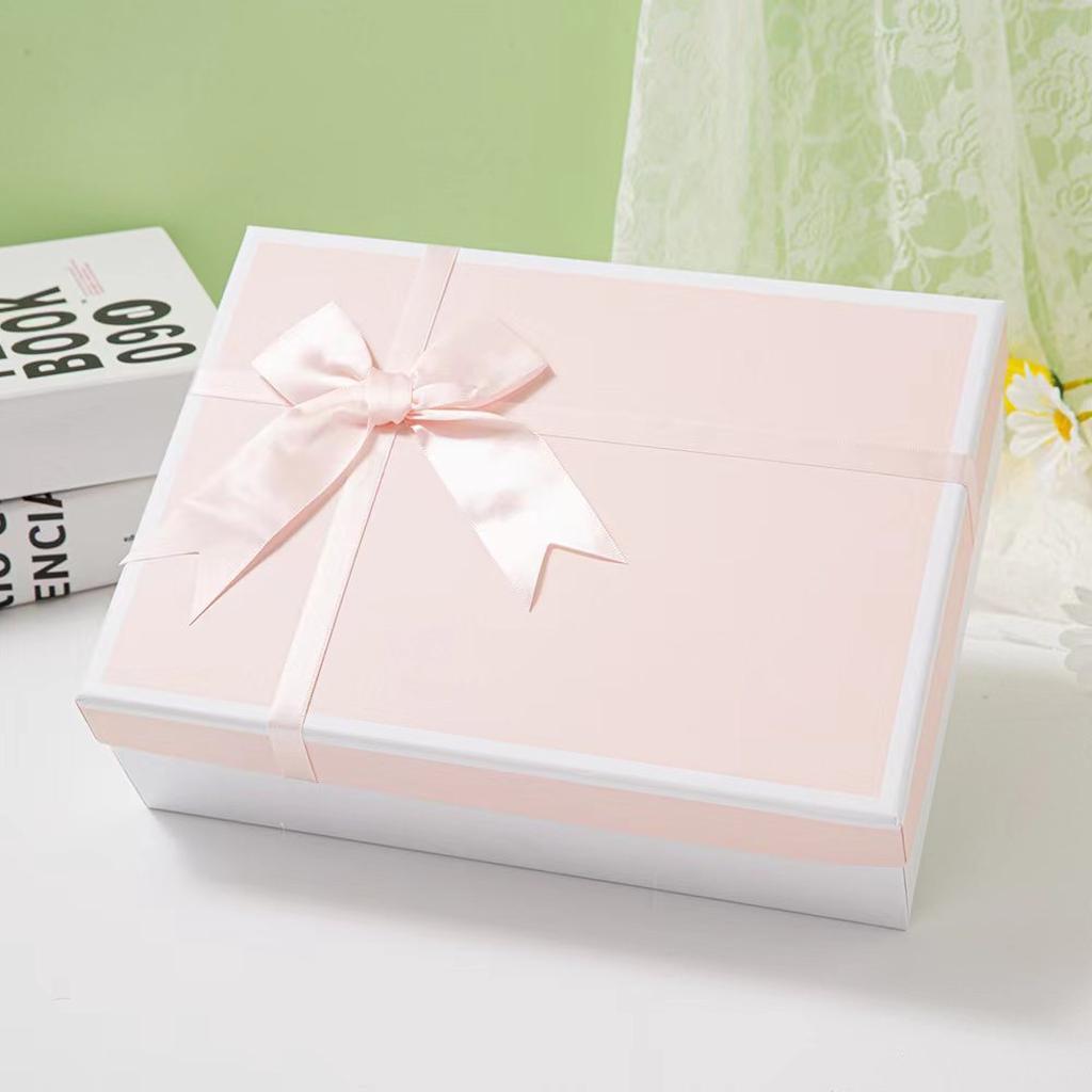 Pink Gift Box with Ribbon on White Background