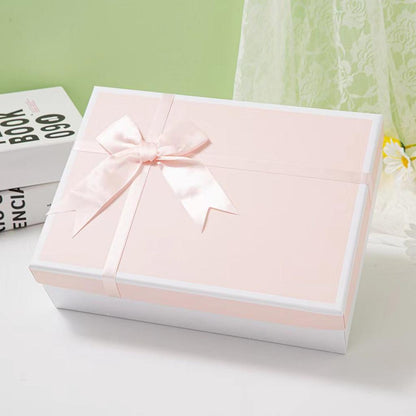 Pink Gift Box with Ribbon on White Background