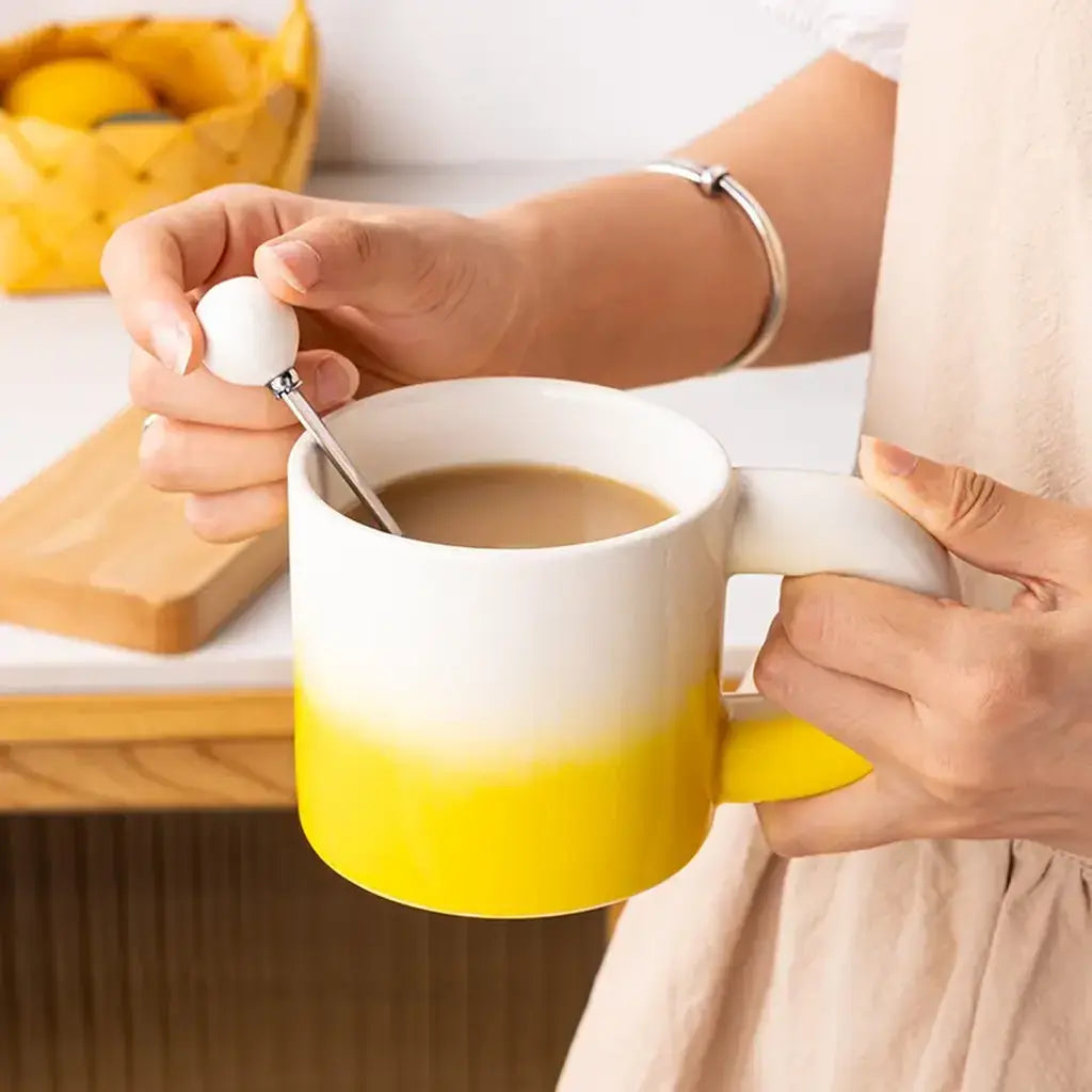 Woman Stirring Coffee In Yellow Gradient Mug
